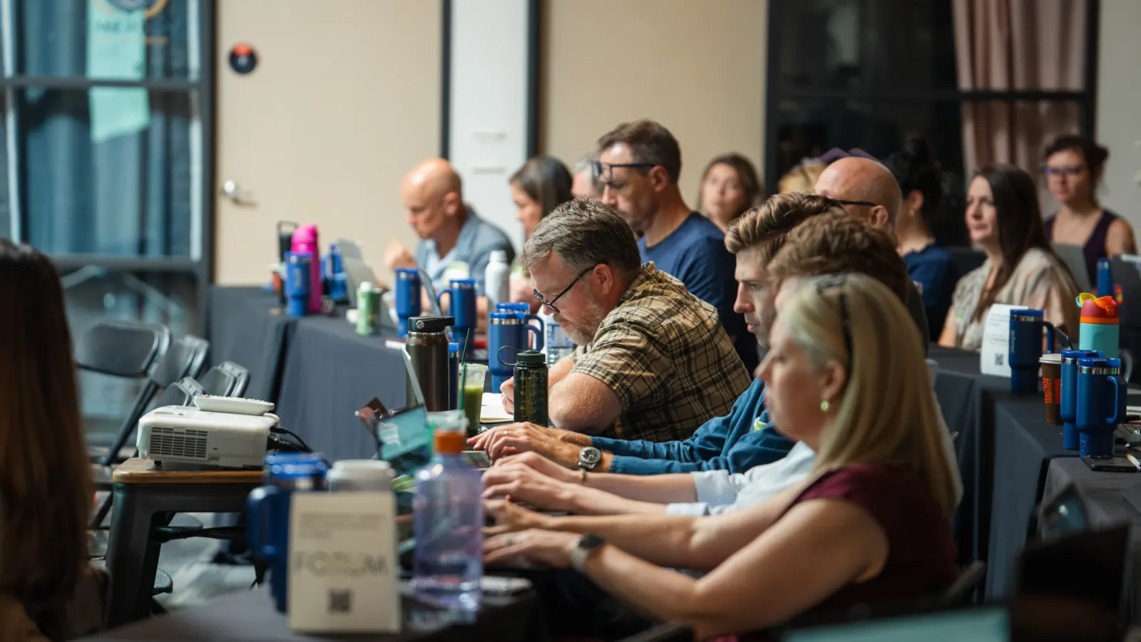 Marketers working on laptops during the AI for CPG Summit build session
