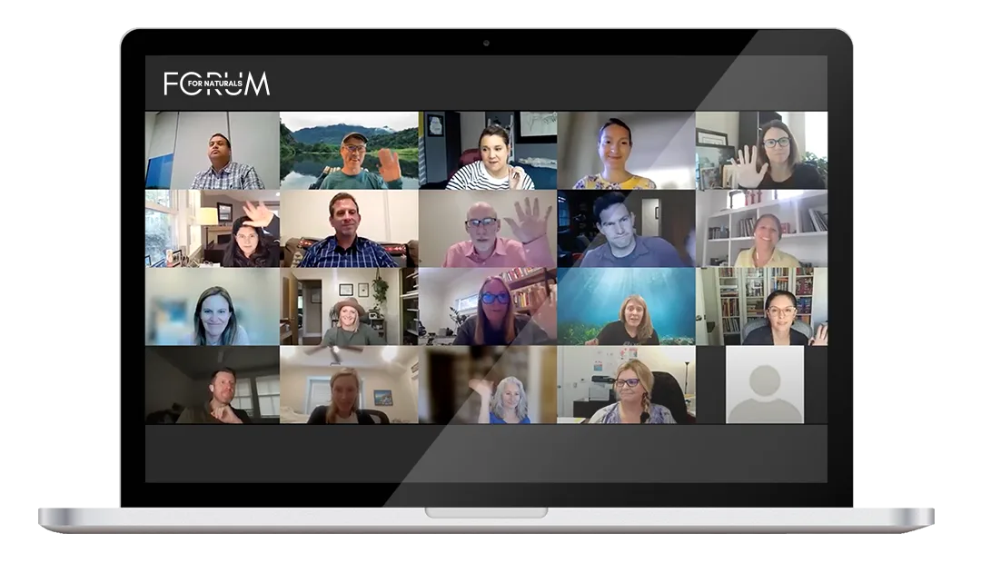 A laptop screen showing a Forum for Naturals virtual session, with a grid of members on video, several waving.